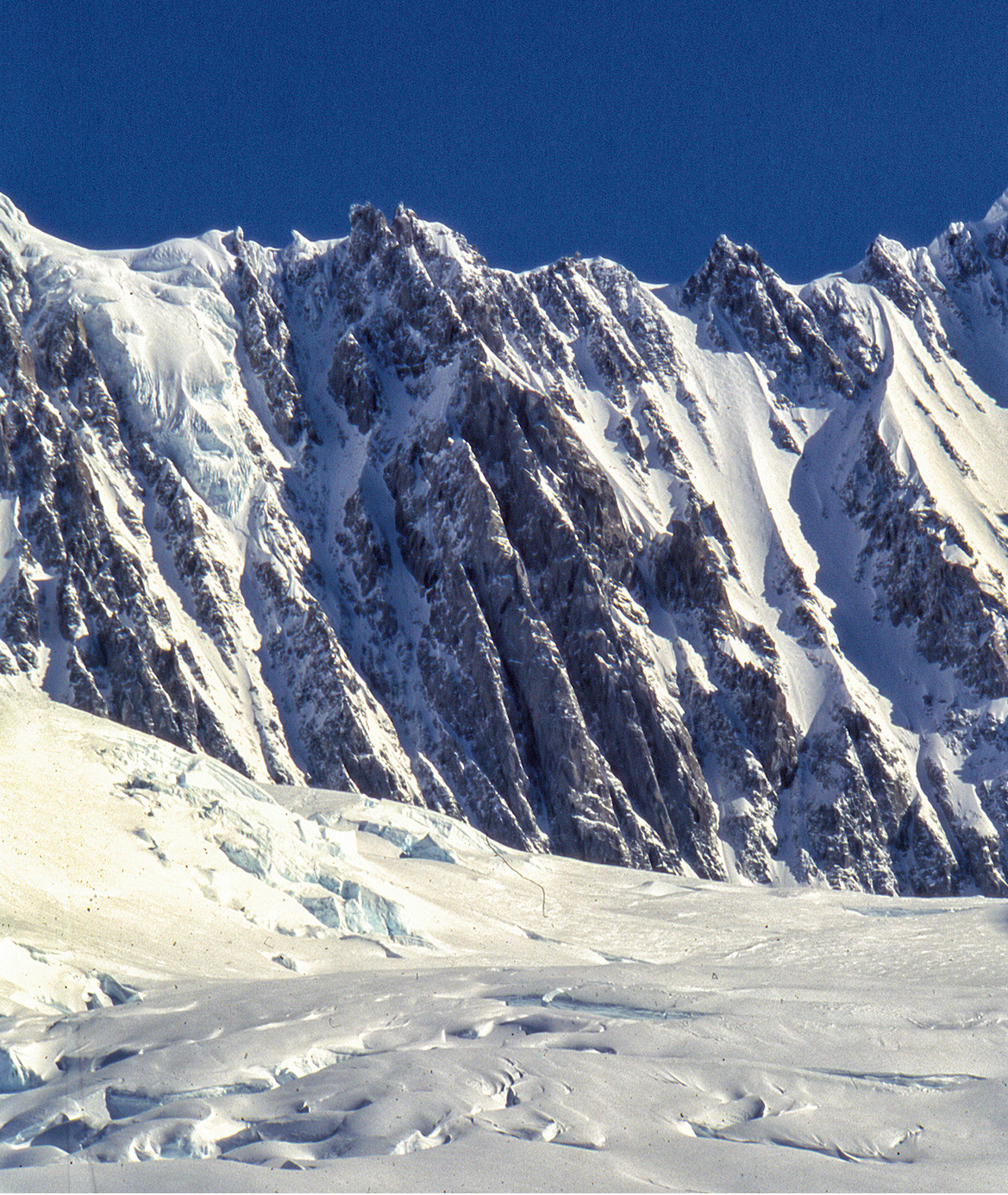 The Pugilist at Rest (5.10 A3 M5) follows the long center rib in the middle of the photo. The Wilford Couloir is the gully just to the left. [Photo] Mark Wilford