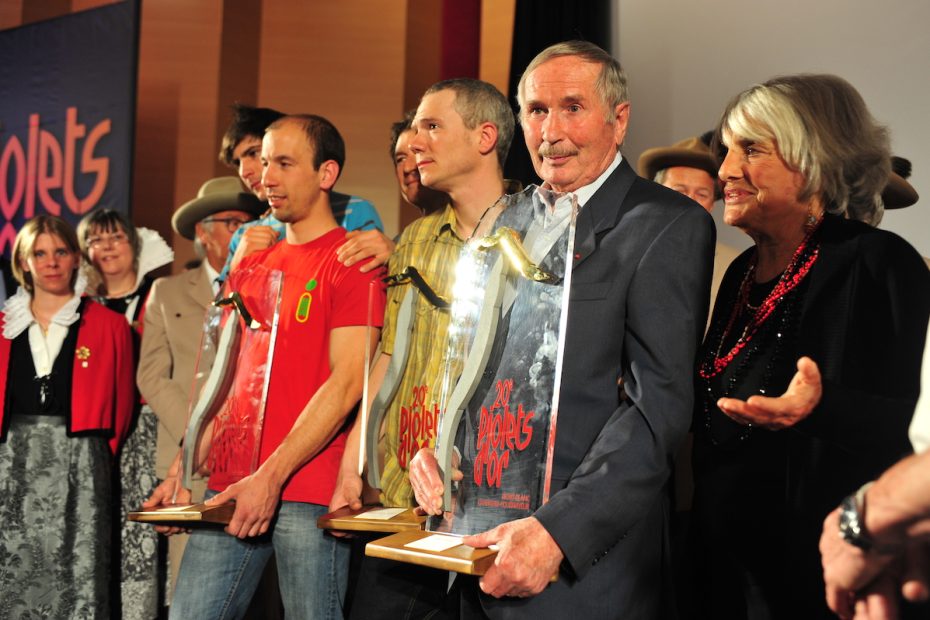 Paragot receiving the Piolets d'Or Lifetime Achievement (aka Walter Bonatti) Award in 2012. Rossana Podesta, Bonatti's partner of 30 years, is on the right. [Photo] Courtesy of Pascal Tournaire