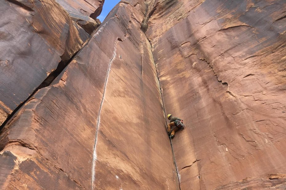 A climber leads Three Strikes You're Out (5.11, 90') on the Battle of the Bulge Buttress in Indian Creek, Utah. The area is part of Bears Ears National Monument where US Interior Secretary Ryan Zinke is conducting a visit as part of his review of all national monuments designated in the last 21 years--as ordered by President Donald Trump in April. Conservation groups fear the unprecedented review could result in these monuments being rescinded or reduced. [Photo] Derek Franz