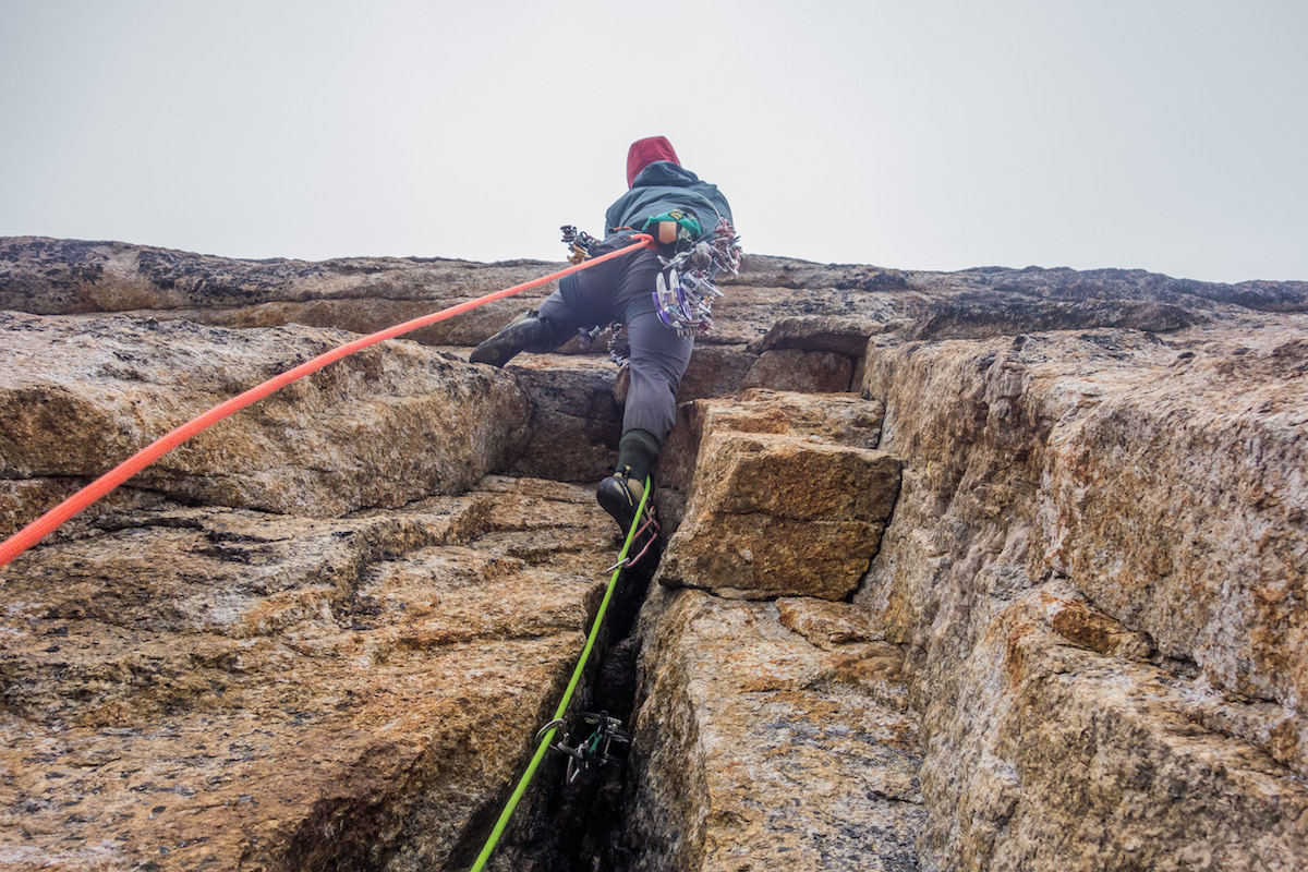Brian Prince onsights the 5.11+ finger crack over a roof on their Xanadu route Arctic Knight (V 5.11+, 7 pitches, ca. 1,600'). [Photo] Vitaliy Musiyenko