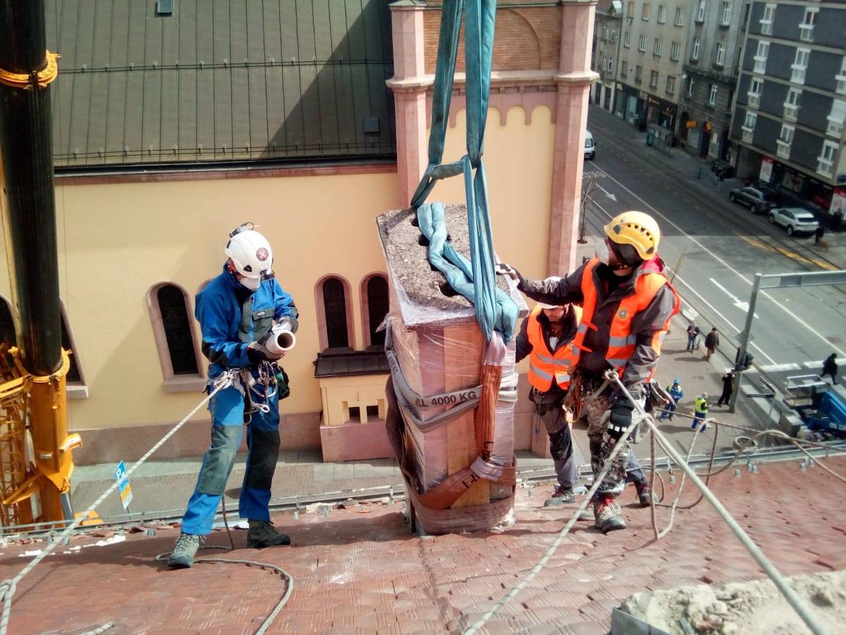Jagor Koprek and two unidentified volunteers remove a damaged chimney above Vlaska Street in the center of Zagreb, Croatia. Koprek is one of the organizers of the volunteer movement to help clean up dangerous debris from city rooftops after the March 22 earthquake that rocked the country's capital. [Photo] Ivica Sturlan