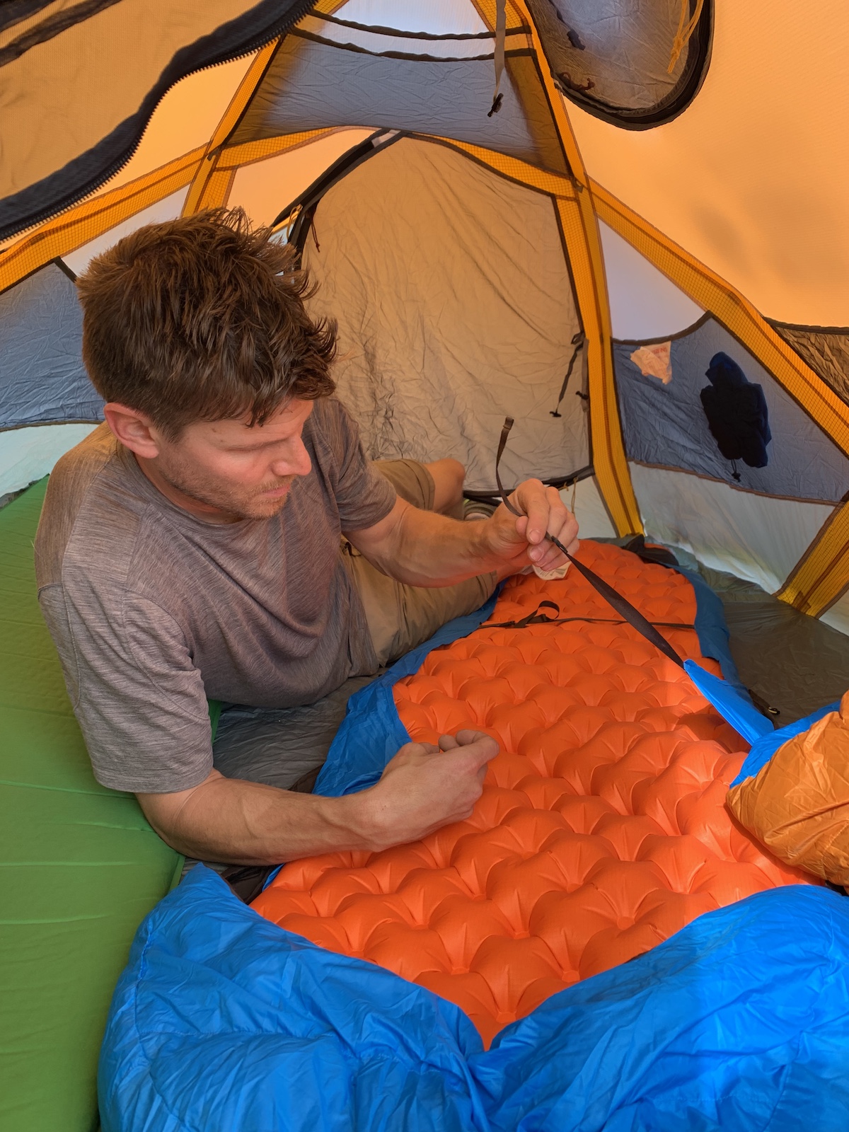 Franz attaches the Zenbivy sheet to his air mattress. [Photo] Mandi Franz